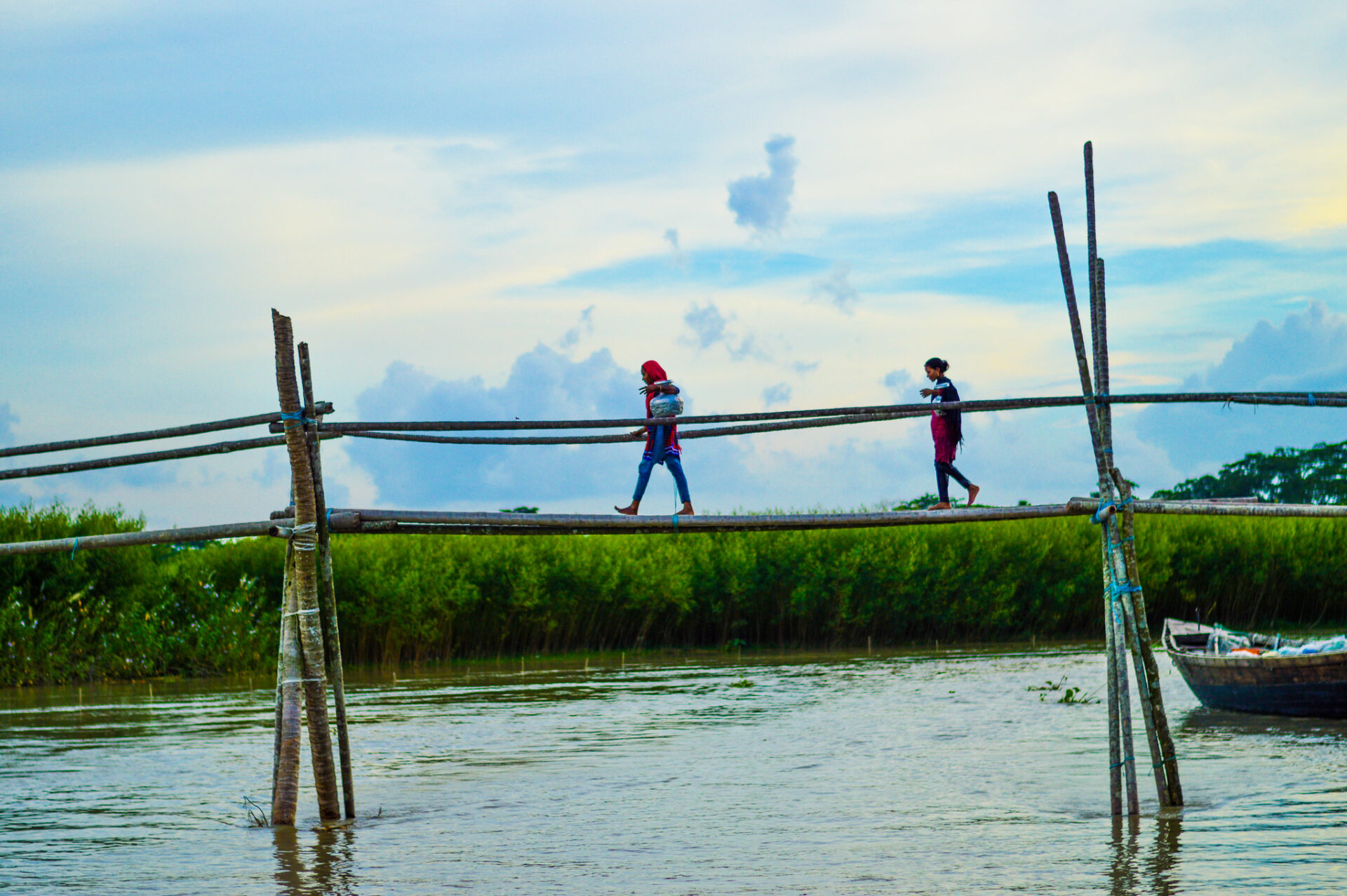 Children crossing bamboo bridge, Bangladesh