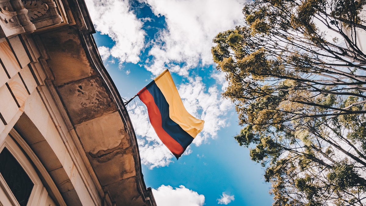 Colombian flag with the blue sky on background.