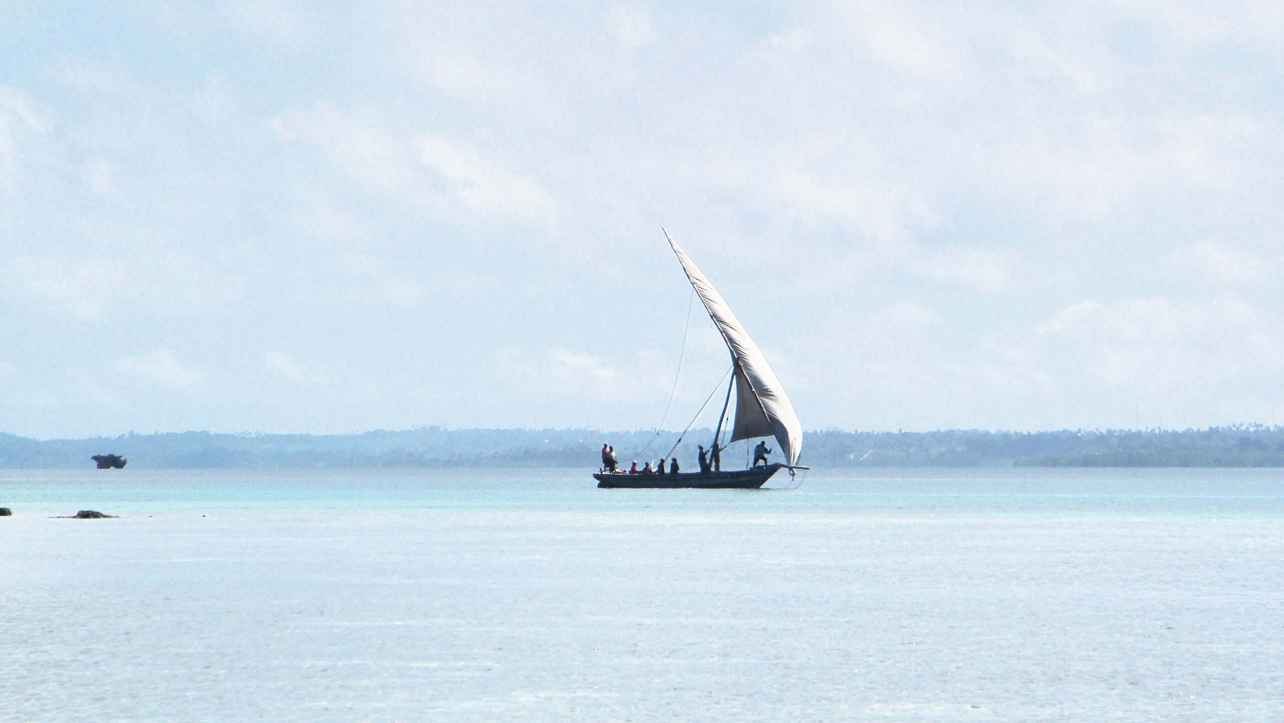 Fishermen on traditional dhow sailboat off the coast of Pemba, Tanzania