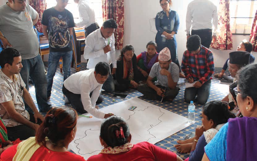 People gathered around a map in a sunny room