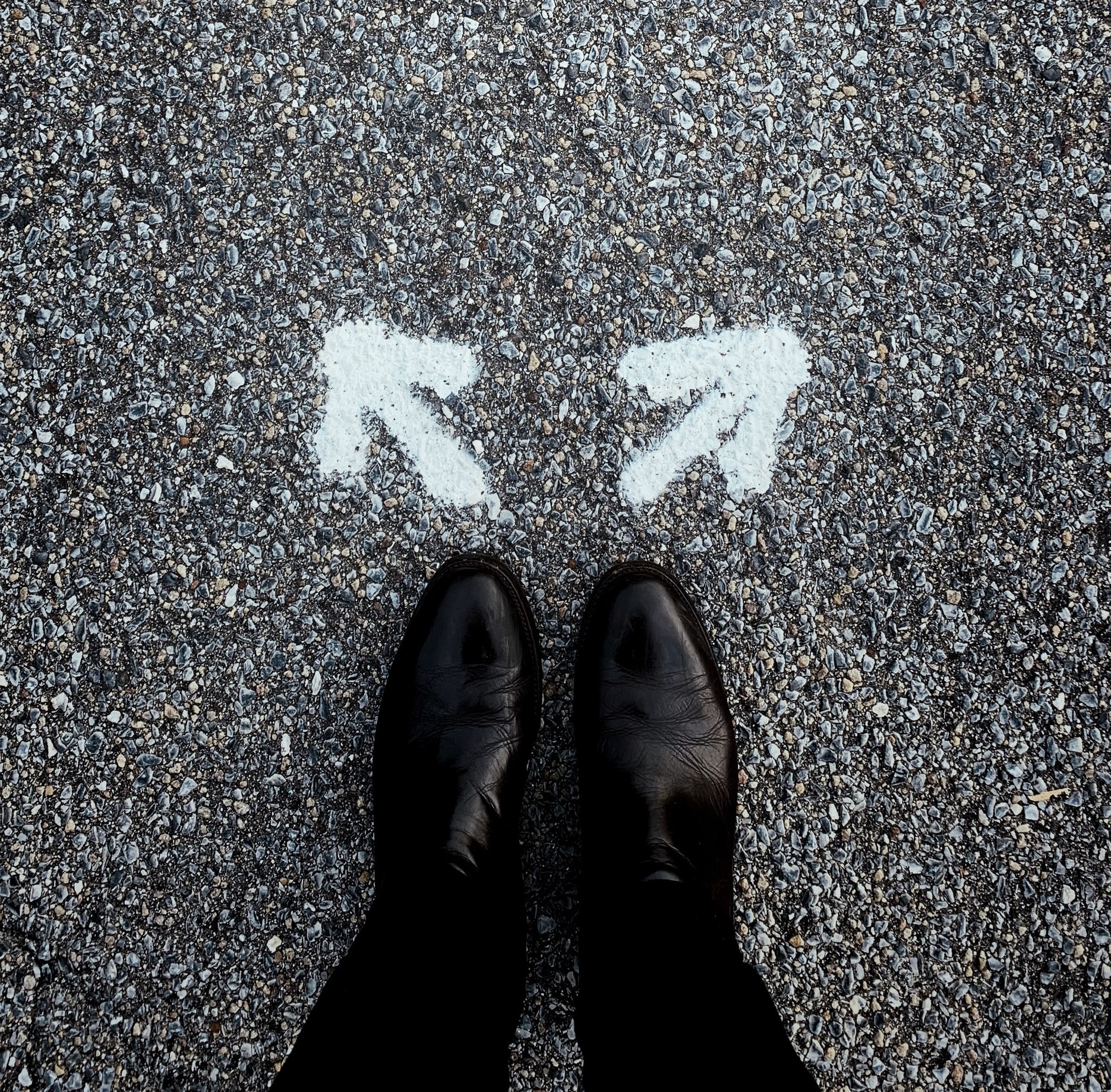 Photograph of feet with two arrows on the ground