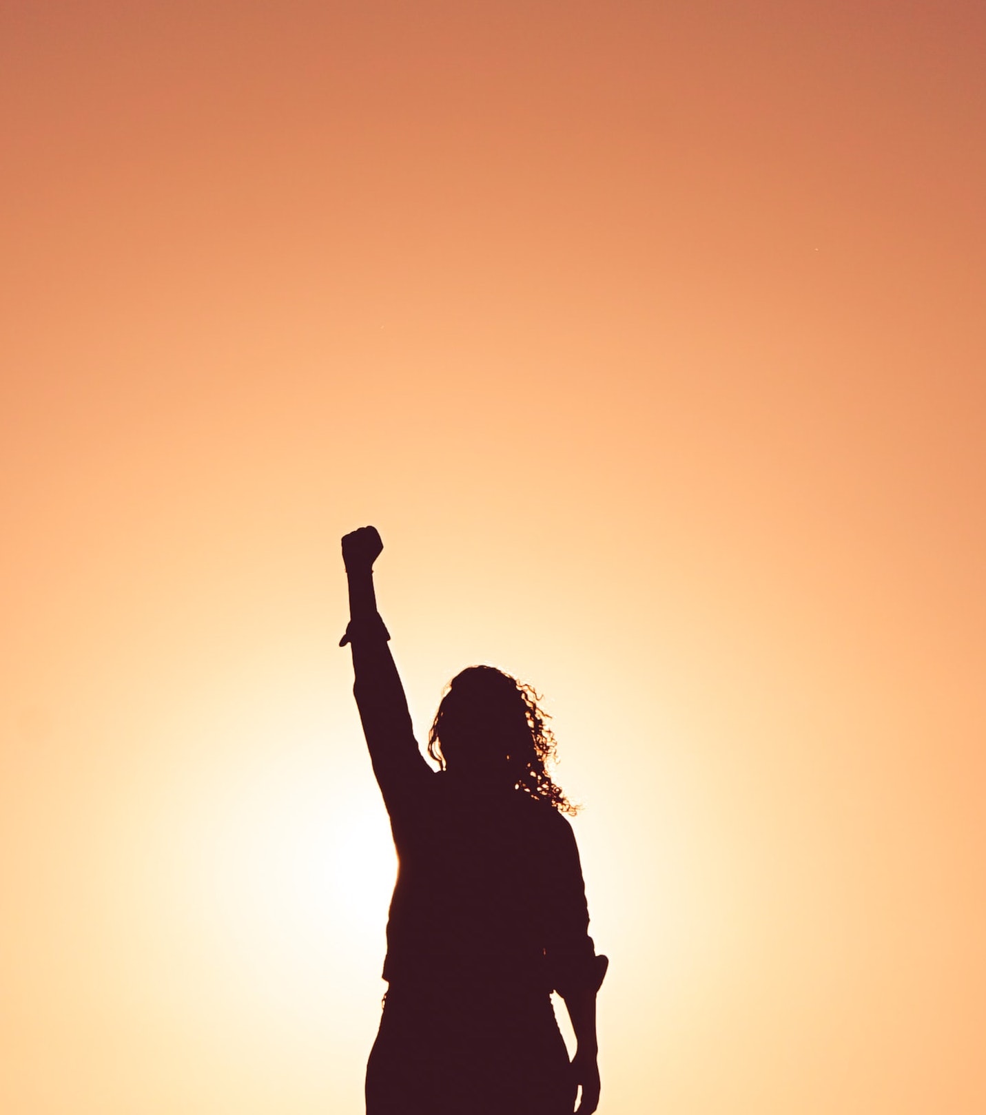 Photograph of woman holding up a fist