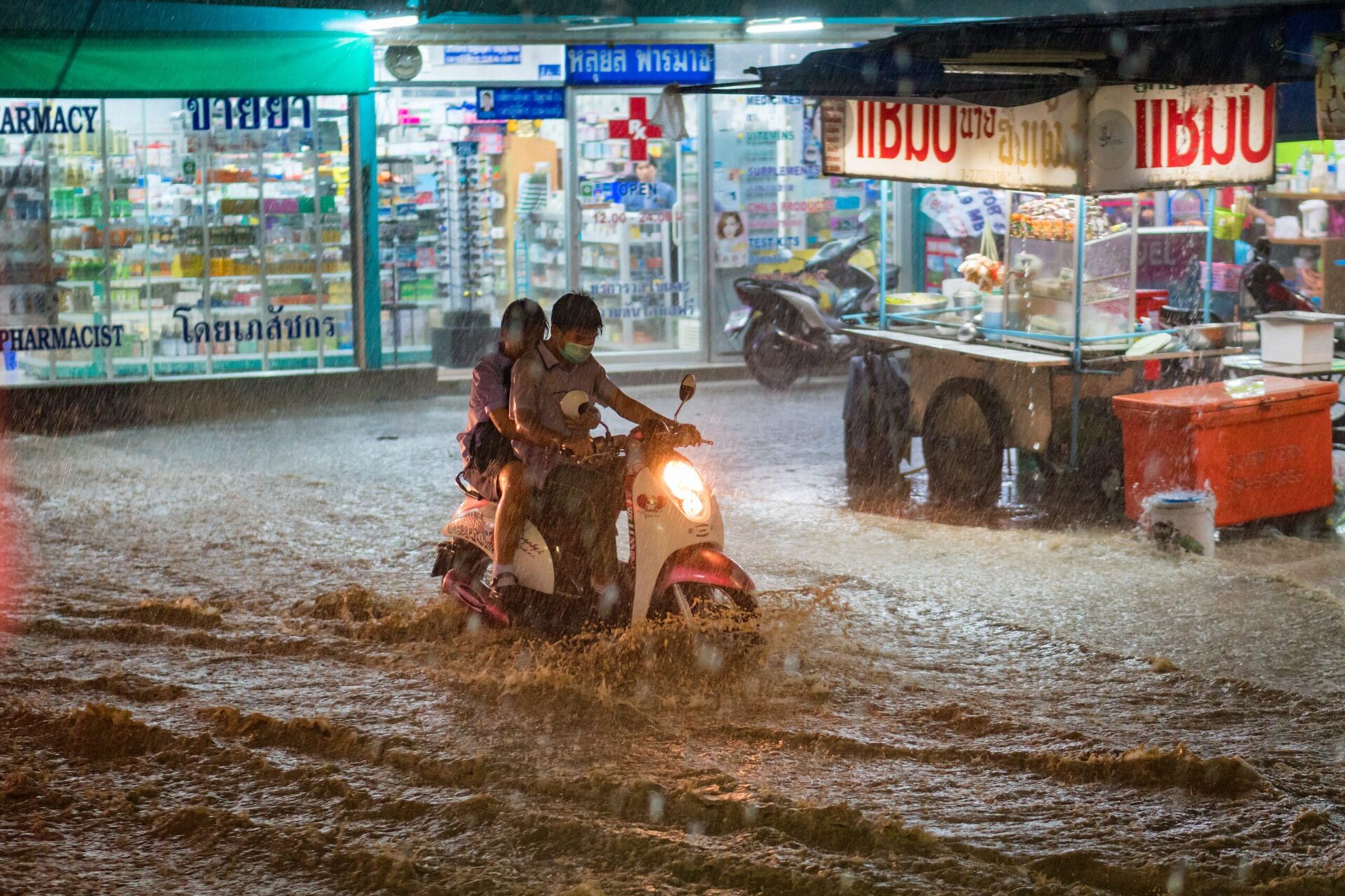 Motorbike navigates flash flood in Thailand