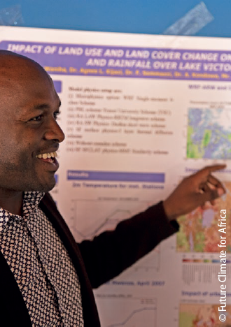 A man smiles and points at a poster showing research results about climate change