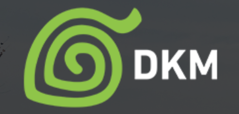 a green spiral leaf next to the initials DKM