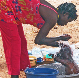 Woman washing a child in Burkina Faso