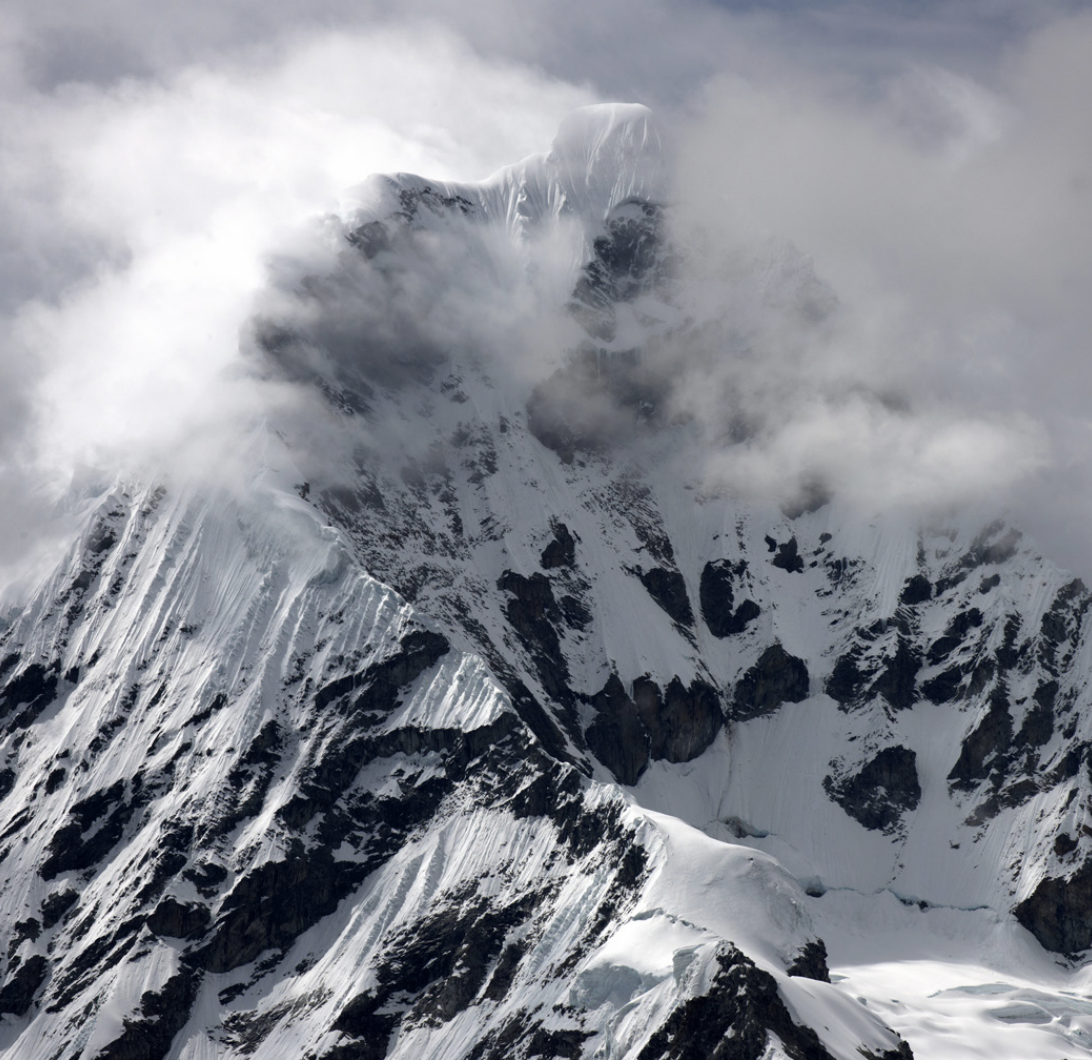 Peru high mountains: mountain peaks covered in snow and clouds
