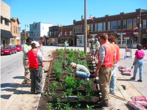 A group of people planting in an urban centre.